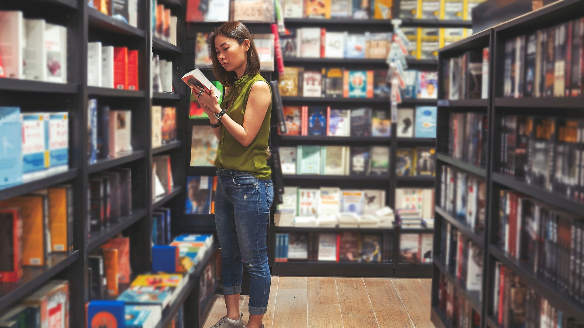 photo of woman browsing books in bookshop